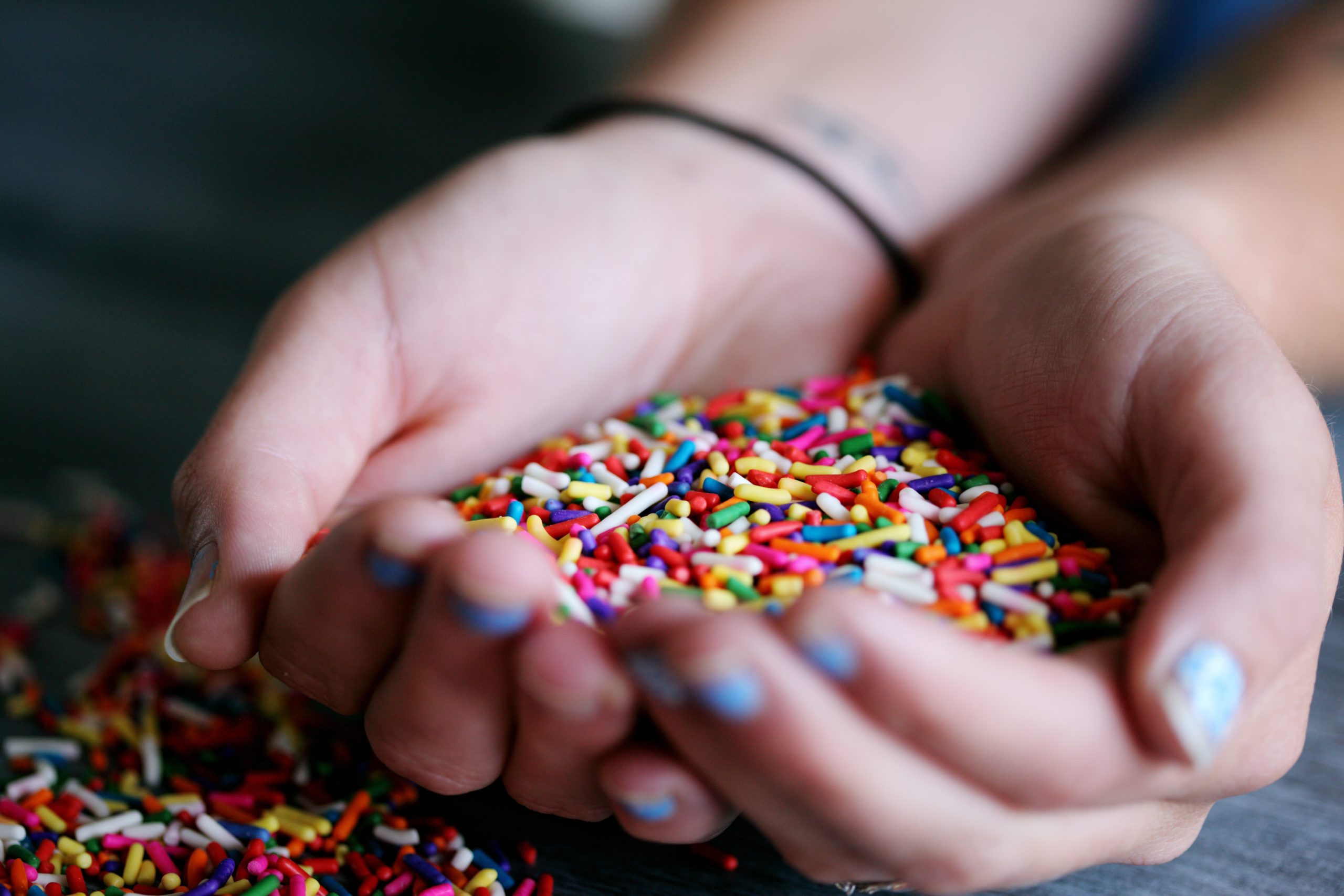 Person Holding Full of Sprinkles by Sharon McCutcheon