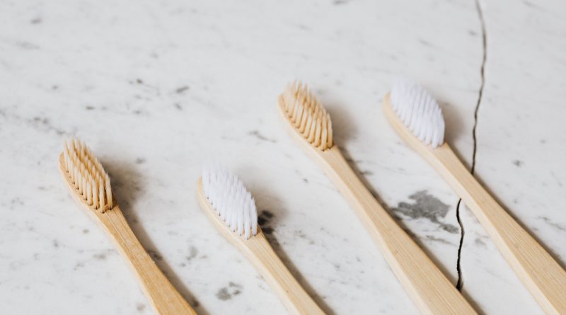 Four Toothbrush on White Surface by Karolina Grabowska